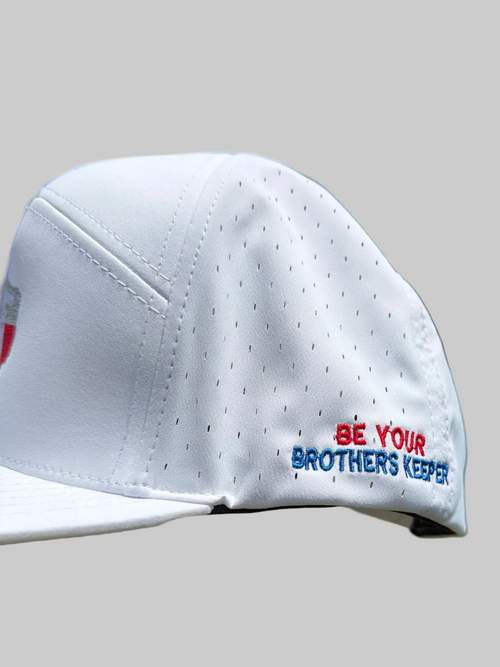White cap with text 'Be Your Brother's Keeper' on a grassy background